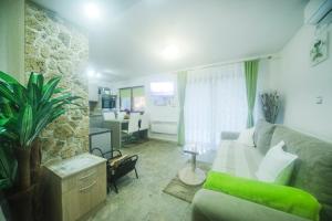 a living room with a couch and a table at Moonriver Apartment in Veljun