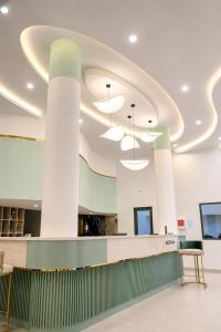 a lobby with white columns and a reception counter at Y Hotel Lý Hồng Thanh in Can Tho