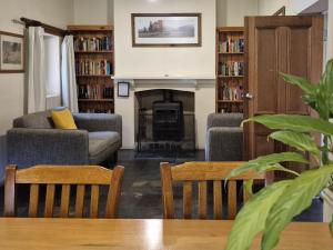 a living room with two chairs and a fireplace at Bungaree Station in Clare