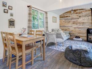 a living room with a wooden table and chairs at Hoy Hideaway in Whitwell