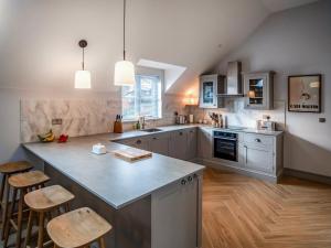 a kitchen with a large island in the middle at Pandy Newydd in Trefriw