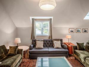 a living room with a couch and a table at Pandy Newydd in Trefriw