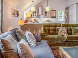 a living room with a couch and a kitchen at Pandy Newydd in Trefriw +17 photos