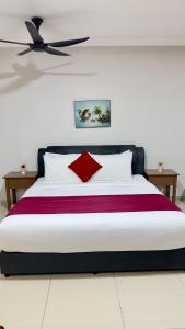 a bedroom with a large bed with a red pillow at Damai Laut Serene Stay Studio Lumut in Lumut +11 photos