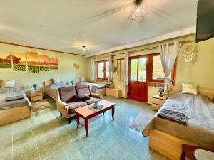 a large living room with a couch and a bed at Lavanda Vendégház in Németkér