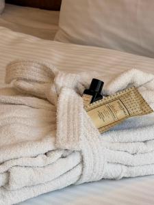 a white towel on a bed with a measuring tape at Waves Hotel NEW IN 2026 in Sarajevo +29 photos