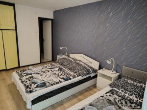 a bedroom with a bed and a wall mural at Villa Malazzo in Balatongyörök