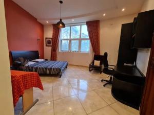 a living room with a bed and a piano at Hill Cottage in Moshi