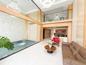 a living room with a swimming pool and a couch at Verdant Apartment & Hotel in Dong Hoi