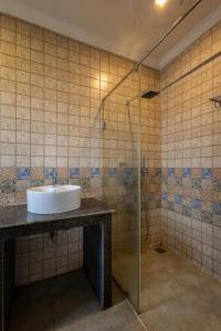 a bathroom with a sink and a shower at The Baga Pescador in Baga +9 photos