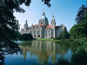 a large building sitting on top of a body of water at Fora Hotel Hannover by Mercure in Hannover