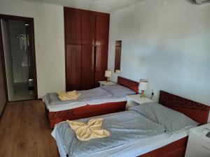 a bedroom with two beds and a mirror at Villa Malazzo in Balatongyörök +36 photos