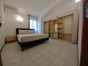 a bedroom with a bed in a room with shelves at Isola Riambel in Riambel