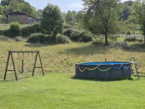 a swing set and a trampoline in a field at El Conventu del Asturcon in Lago