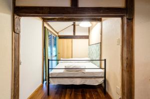 a bedroom with a bunk bed in a room at Kume Guest House in Kumejima