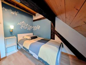 a bedroom with a bed and a wooden ceiling at Le Chalet Cozy & Spa in Wildersbach +24 photos
