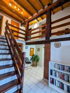 a staircase in a house with bookshelves at Le Chalet Cozy & Spa in Wildersbach