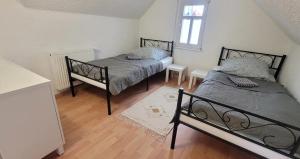 a bedroom with two beds and a window at Revant West 3 in Arnstadt