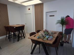 a person standing in a room with tables and chairs at H SENDA ReAL in Alcuéscar +6 photos