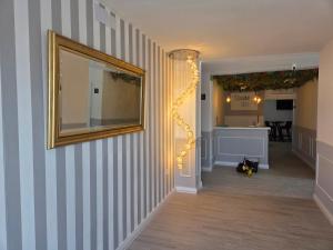 a hallway with a mirror on the wall and a mirror at H SENDA ReAL in Alcuéscar