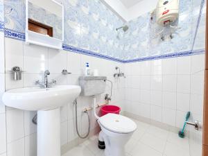 a bathroom with a sink and a toilet at Hotel Pinecrest Inn Darjeeling With Mountain View Room And Parking - Restaurant Facility in Darjeeling +21 photos