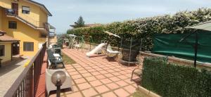 a balcony with a playground with benches and a fence at Complesso Turistico Aurora - camere & Appartamenti in Poggio Picenze +131 photos