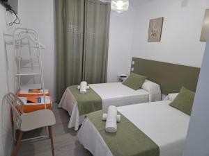 a small room with two beds and a ladder at H SENDA ReAL in Alcuéscar