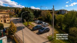 a group of cars parked in a parking lot at Complesso Turistico Aurora - camere & Appartamenti in Poggio Picenze