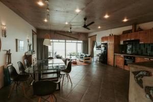 a kitchen and dining room with a table and chairs at Balay Kalachuchi in Barili +48 photos
