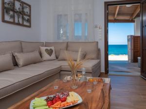 a living room with a couch and a table with a plate of fruit at Marelia Memories villa in Skaleta