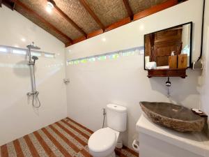 a bathroom with a sink and a toilet at Pondok Risky in Tegalalang +44 photos