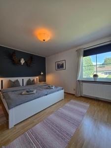 a bedroom with a large bed and a large window at Villa Edda in Vidsel