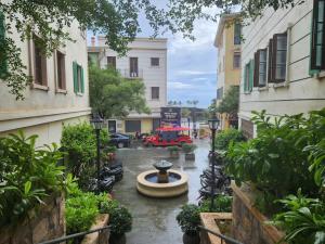 a street with a fountain and a red truck at Sunset Bridge Hotel Phu Quoc in Phú Quốc