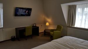 מיטה או מיטות בחדר ב-Het Hart van Weesp