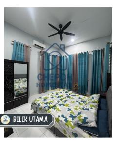 a bedroom with a bed and a ceiling fan at Chepoh Homestay Pasir Mas in Pasir Mas