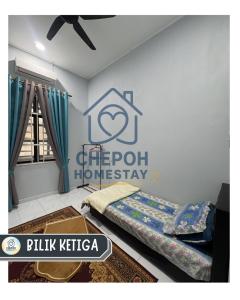 a bedroom with a bed and a sign on the wall at Chepoh Homestay Pasir Mas in Pasir Mas +4 photos