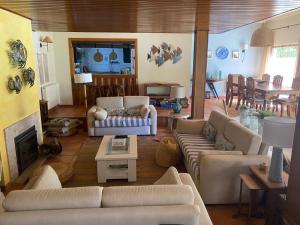 a living room with couches and a fireplace at Aldeamento Turistico Casas da Comporta in Comporta