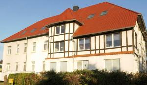 a large white building with an orange roof at Schullandheim Bautzen Burk nahe der Talsperre - Dachkammer deluxe in Bautzen