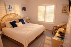 a bedroom with a large bed with blue pillows at Newly Restyled Resort 1 Bedroom Unit Oaks Pacific Blue in Salamander Bay