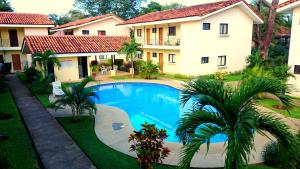 a swimming pool in front of a house at Studio Apartments in Las Torres in Coco