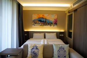 a hotel room with a bed and a couch at Urbitia Thonglor in Klong Toi +27 photos