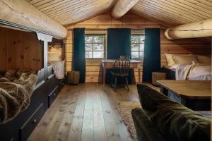 a bedroom with a bed and a desk in a room at Solskiva 23 in Trysil