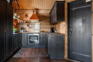 a kitchen with gray cabinets and an open door at Solskiva 23 in Trysil +4 photos
