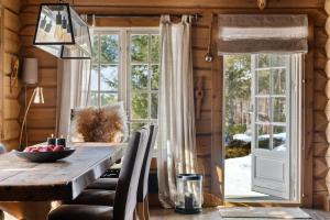 a dining room with a wooden table and a window at Solskiva 23 in Trysil