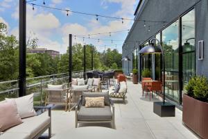 a patio with couches and chairs on a building at Courtyard by Marriott Birmingham Grandview in Birmingham