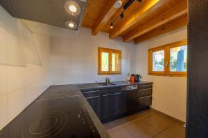 a kitchen with a sink and a counter top at Chalet La Tirelire in Nendaz