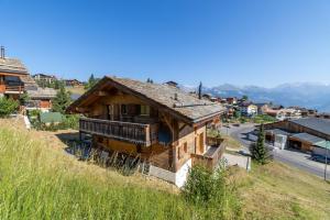 an old wooden house on a hill in a village at Chalet La Tirelire in Nendaz