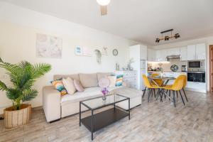 a living room with a couch and a table at Paz Ocean View, 2 Air Conditioners, Wifi, Heated pool in San Miguel de Abona
