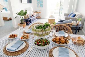 a table with dishes of food on it at Newly Restyled Resort 1 Bedroom Unit Oaks Pacific Blue in Salamander Bay
