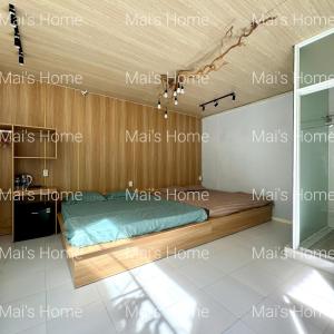 a room with a bed and a wooden ceiling at Mai Home in Ấp An Mỹ